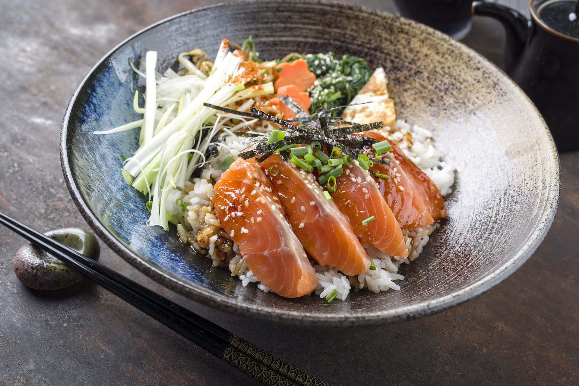 Traditional Salmon Sashimi Donburi with Rice and Vegetable as cl